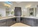 Luxurious bathroom with dual sinks, marble countertops, and ample cabinet space at 5341 Greenbrook Dr, Sarasota, FL 34238