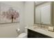 Powder room featuring a decorative mirror and charming tree artwork on the wall at 5341 Greenbrook Dr, Sarasota, FL 34238