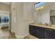 Bright bathroom featuring a vanity, natural light, and wood-look floor tiles at 5341 Greenbrook Dr, Sarasota, FL 34238