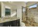 Elegant bathroom featuring granite counters and a beautifully tiled shower with glass doors at 5341 Greenbrook Dr, Sarasota, FL 34238