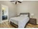 Comfortable bedroom with neutral decor, wood-look tile floors, and an en-suite bathroom providing privacy at 5341 Greenbrook Dr, Sarasota, FL 34238
