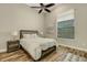 Cozy bedroom featuring neutral tones, wood-look floors, a ceiling fan, and a bright window at 5341 Greenbrook Dr, Sarasota, FL 34238