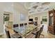 Bright dining room featuring a glass table, leather chairs, wood floors, and a decorative chandelier and ceiling at 5341 Greenbrook Dr, Sarasota, FL 34238