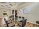 Dining room with a glass table, leather chairs, and a decorative chandelier and ceiling at 5341 Greenbrook Dr, Sarasota, FL 34238