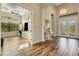 Elegant foyer featuring wood floors, a chandelier, and an adjacent office at 5341 Greenbrook Dr, Sarasota, FL 34238