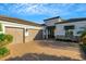 Charming home featuring a spacious two-car garage and stone accents, complemented by a brick driveway at 5341 Greenbrook Dr, Sarasota, FL 34238