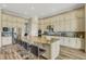 Bright kitchen with ample white cabinetry, stainless steel appliances, a large island, and a breakfast bar at 5341 Greenbrook Dr, Sarasota, FL 34238