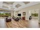 Spacious living room with wood floors, comfortable leather seating, and access to the outdoor patio at 5341 Greenbrook Dr, Sarasota, FL 34238