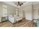 Spacious primary bedroom with a tray ceiling, wood floors, and neutral decor at 5341 Greenbrook Dr, Sarasota, FL 34238