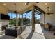 Spacious screened patio with outdoor seating, a cozy fireplace, ceiling fans, and relaxing views at 5341 Greenbrook Dr, Sarasota, FL 34238