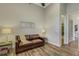 Cozy sitting room featuring a leather sofa, lamps, and stylish flooring at 5341 Greenbrook Dr, Sarasota, FL 34238
