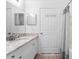 Bathroom featuring granite countertops, tile flooring, and a convenient towel hook rack on the door at 5711 Soldier Cir # 204, Sarasota, FL 34233