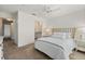 Cozy bedroom with a woven headboard, ensuite bathroom access, and a ceiling fan at 5711 Soldier Cir # 204, Sarasota, FL 34233