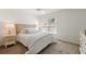 Bright bedroom with white bedding, a woven headboard, and a window with natural light at 5711 Soldier Cir # 204, Sarasota, FL 34233