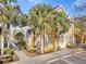 Charming two-story townhouse surrounded by mature palm trees and a well-maintained landscape at 5711 Soldier Cir # 204, Sarasota, FL 34233
