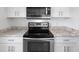 Modern kitchen featuring stainless steel appliances, white cabinets, and granite countertops at 5711 Soldier Cir # 204, Sarasota, FL 34233