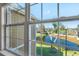 Scenic window view overlooking a tranquil lake, lush greenery, and the community pool at 5711 Soldier Cir # 204, Sarasota, FL 34233