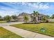 Attractive single-story home with a well-maintained lawn, landscaping, a paver driveway, and a two-car garage at 6428 Devesta Loop, Palmetto, FL 34221