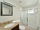 Clean bathroom featuring granite countertop vanity, a framed mirror, and a shower/tub combo at 6589 Fairway Gardens Dr # 202, Bradenton, FL 34203