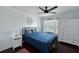 Comfortable bedroom with a blue bed, white dresser, and a large window providing natural light at 6589 Fairway Gardens Dr # 202, Bradenton, FL 34203