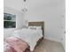 Bright bedroom features a bed with a wicker headboard, and a vibrant light fixture at 6669 Windjammer Pl, Lakewood Ranch, FL 34202