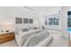 Bright bedroom with white walls, and modern furnishings including a decorative rug and bedside tables at 6669 Windjammer Pl, Lakewood Ranch, FL 34202