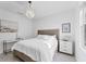 Clean bedroom with white bedding and a wicker bed frame and coastal decor at 6669 Windjammer Pl, Lakewood Ranch, FL 34202