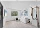 Bright exercise room featuring a white sectional sofa, large window, and exercise equipment at 6669 Windjammer Pl, Lakewood Ranch, FL 34202