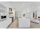 Bright kitchen featuring a long island with seating, stainless steel appliances, and open floor plan at 6669 Windjammer Pl, Lakewood Ranch, FL 34202