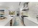 Modern kitchen with sleek white cabinets, stainless steel appliances, and spacious countertops at 6669 Windjammer Pl, Lakewood Ranch, FL 34202