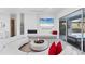 Modern living room with a sleek fireplace, large screen TV, and access to the pool at 6669 Windjammer Pl, Lakewood Ranch, FL 34202