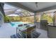 Relaxing covered patio and outdoor kitchen overlooking sparkling pool at 6669 Windjammer Pl, Lakewood Ranch, FL 34202