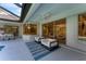 Screened outdoor patio with white chairs and a view of the house through sliding glass doors at 6669 Windjammer Pl, Lakewood Ranch, FL 34202