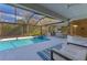 A stunning screened pool and spa with an outdoor kitchen and ample patio space for entertaining at 6669 Windjammer Pl, Lakewood Ranch, FL 34202