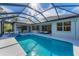 Enjoy this beautiful screened-in pool with outdoor kitchen and ample seating areas for relaxing and entertaining at 6669 Windjammer Pl, Lakewood Ranch, FL 34202