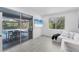 Bright sitting area with a view of the pool, a white couch, and tile floors at 6669 Windjammer Pl, Lakewood Ranch, FL 34202
