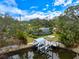 Aerial view showcasing the home's waterfront location, private boat dock, screened-in pool, and mature landscaping at 121 Holly Ave, Sarasota, FL 34243