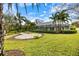 Spacious backyard featuring a screened-in lanai and a paved patio area, perfect for outdoor entertaining at 121 Holly Ave, Sarasota, FL 34243
