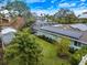 Beautiful backyard featuring lush greenery, a screened-in pool enclosure, and solar panels at 121 Holly Ave, Sarasota, FL 34243