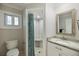 Well-lit bathroom with a tiled shower, marble countertops, and modern fixtures for a sleek design at 121 Holly Ave, Sarasota, FL 34243
