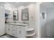 Bathroom featuring a double sink vanity, modern fixtures, and walk-in shower, offering a serene and functional space at 121 Holly Ave, Sarasota, FL 34243
