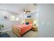 Well-lit bedroom with a ceiling fan, bright colored bedding, and a window providing natural light at 121 Holly Ave, Sarasota, FL 34243