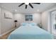 Comfortable bedroom with a ceiling fan, artwork, and access to the outdoors, creating a relaxing retreat at 121 Holly Ave, Sarasota, FL 34243