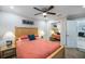 Comfortable bedroom features a ceiling fan, two bedside lamps, and a sliding mirror closet at 121 Holly Ave, Sarasota, FL 34243
