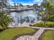 Private dock with boat lift featuring a paved walkway and lush landscaping in a waterfront community at 121 Holly Ave, Sarasota, FL 34243
