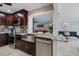 Modern kitchen featuring granite countertops, stainless steel appliances, and dark wood cabinetry at 121 Holly Ave, Sarasota, FL 34243