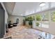 Enclosed lanai with tiled floors, comfortable seating, and bright, natural light at 121 Holly Ave, Sarasota, FL 34243