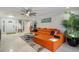 Open living space with a contemporary orange sofa, accent rug, and stylish décor at 121 Holly Ave, Sarasota, FL 34243