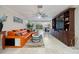 A luxurious living room featuring an orange leather sofa and built-in shelving for modern living at 121 Holly Ave, Sarasota, FL 34243