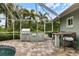 Outdoor kitchen featuring a grill and bar, perfect for entertaining and outdoor dining near the pool at 121 Holly Ave, Sarasota, FL 34243